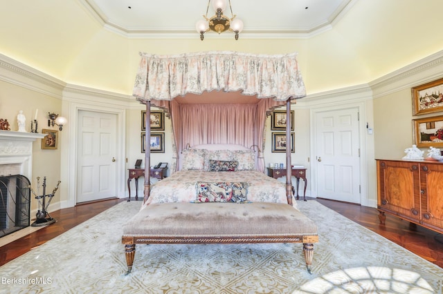 bedroom with dark parquet flooring, crown molding, and a notable chandelier