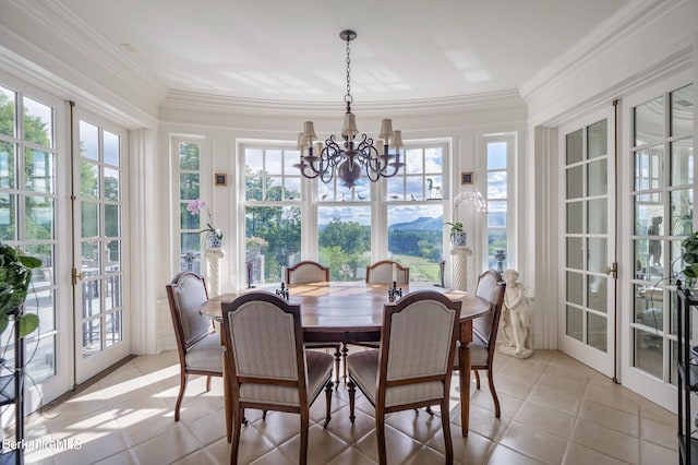 sunroom featuring a chandelier and french doors