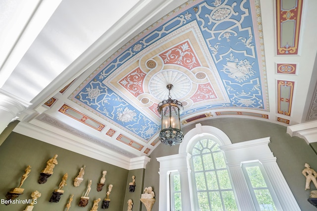 interior details featuring decorative columns, an inviting chandelier, and ornamental molding