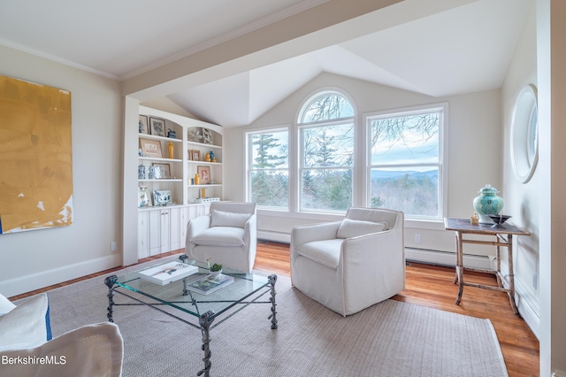 sitting room with built in shelves, light wood-type flooring, vaulted ceiling, and a baseboard heating unit