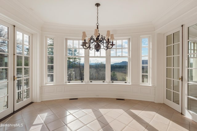 unfurnished sunroom featuring french doors and a chandelier