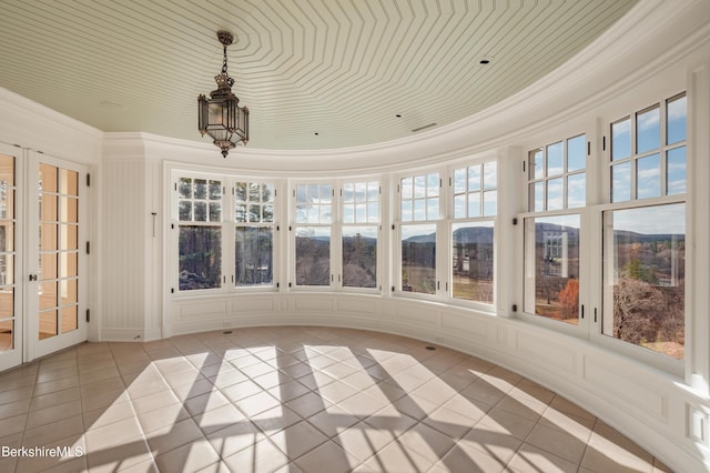 unfurnished sunroom with french doors