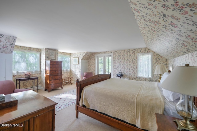 carpeted bedroom with vaulted ceiling and a baseboard heating unit