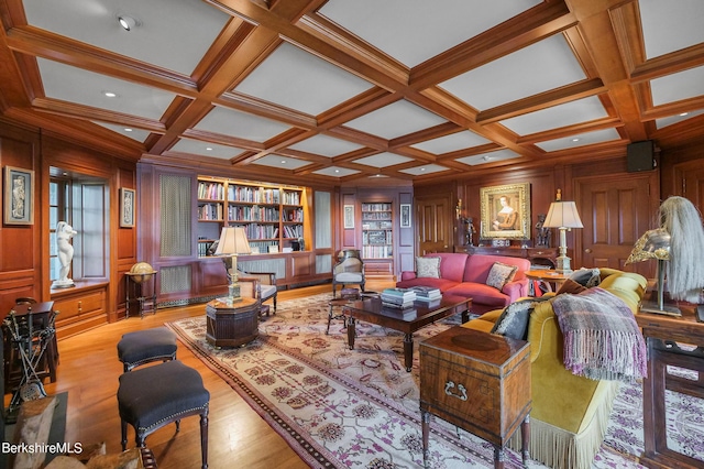 living room featuring coffered ceiling, wooden walls, built in features, beam ceiling, and light hardwood / wood-style floors