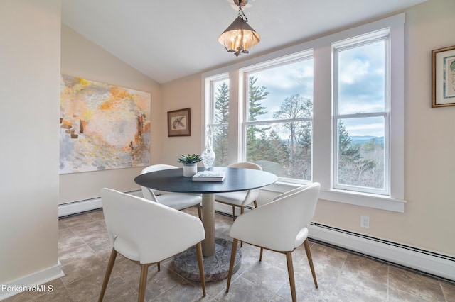 dining area featuring a notable chandelier, vaulted ceiling, and a baseboard heating unit