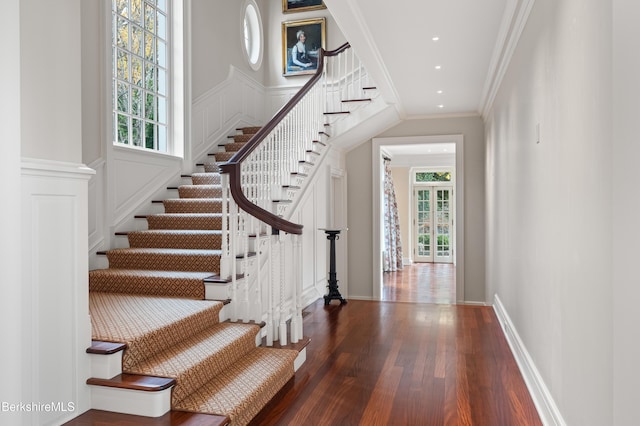 entryway featuring crown molding and dark hardwood / wood-style flooring