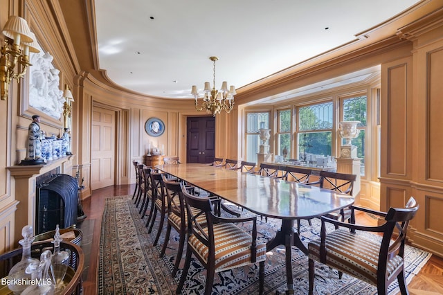 dining space featuring an inviting chandelier, parquet floors, and ornamental molding