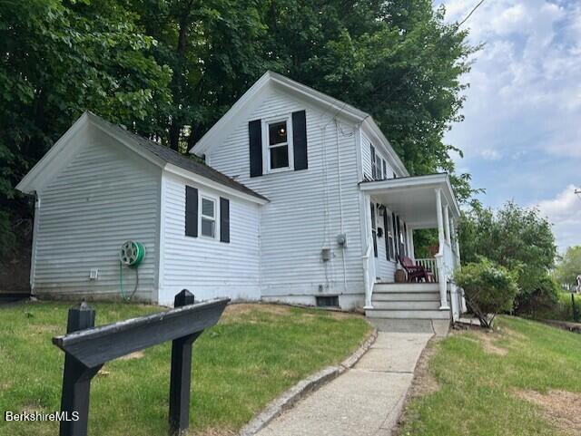 31 Richmond Ln, Adams, MA 01220 - traditional-style house featuring covered porch and a front lawn