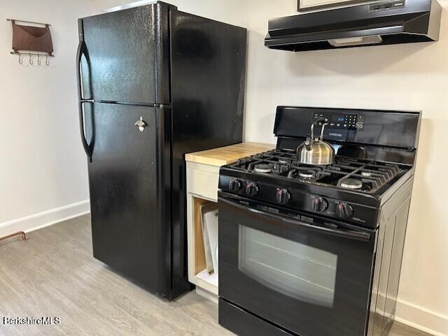 31 Richmond Ln, Adams, MA 01220 - kitchen with black appliances, under cabinet range hood, light wood finished floors, and light countertops