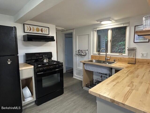31 Richmond Ln, Adams, MA 01220 - kitchen with black appliances, range hood, wood finished floors, and wooden counters