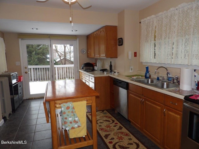 kitchen featuring dark tile patterned flooring, sink, and appliances with stainless steel finishes