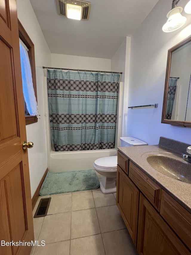 full bathroom featuring tile patterned floors, vanity, shower / tub combo, and toilet