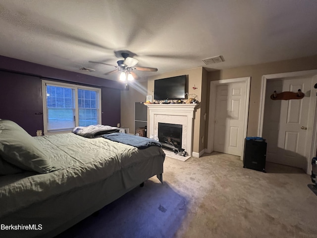 bedroom with ceiling fan and light carpet