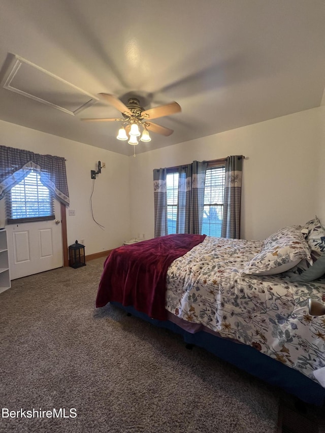 carpeted bedroom with multiple windows and ceiling fan