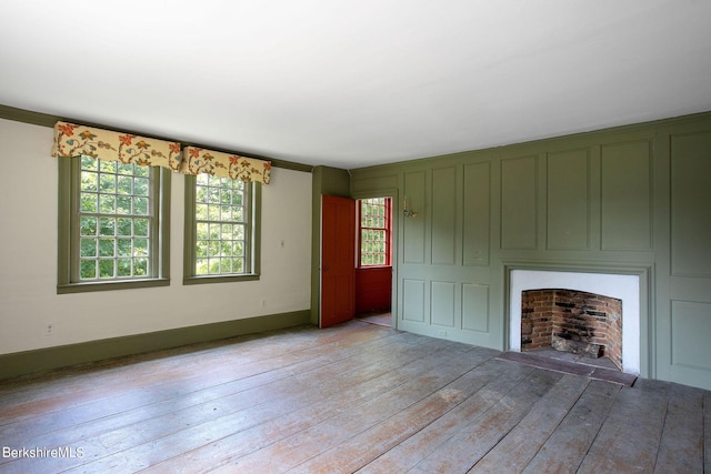 unfurnished living room with light hardwood / wood-style flooring and ornamental molding