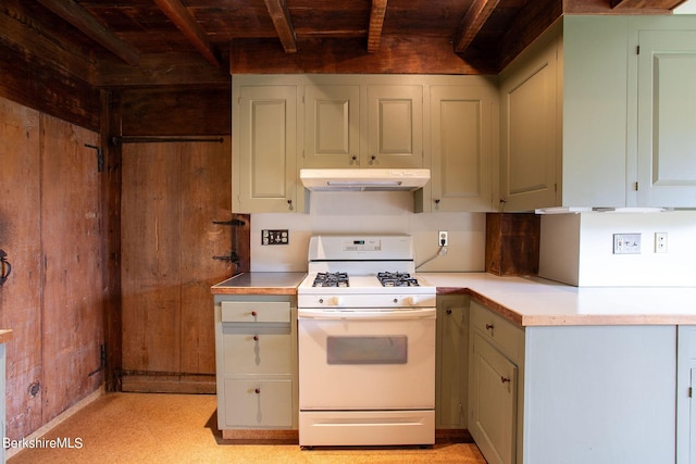 kitchen with wooden walls and white gas stove