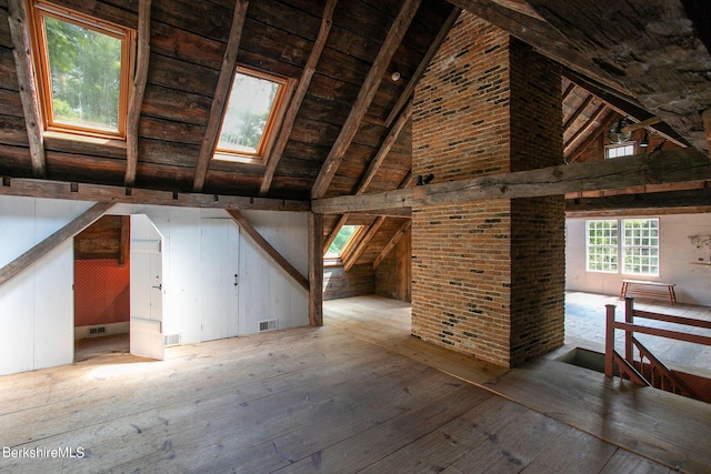 unfinished attic featuring a skylight