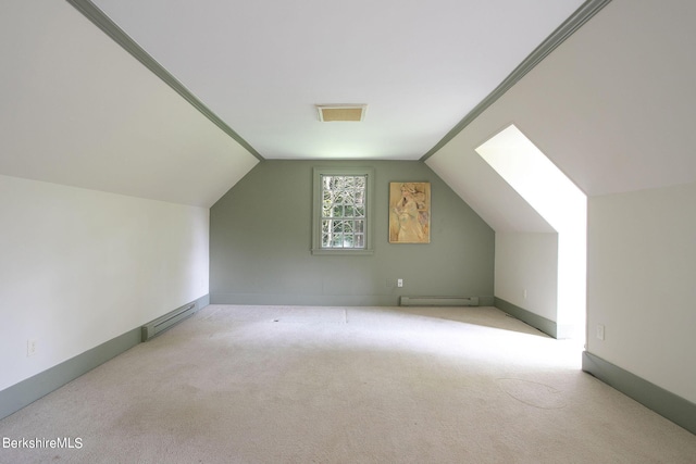 additional living space with vaulted ceiling, light carpet, and a baseboard radiator