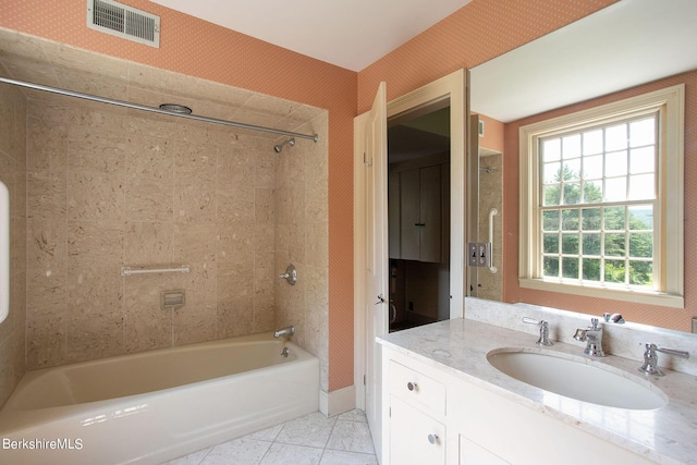 bathroom featuring tile patterned flooring, shower / tub combination, and vanity