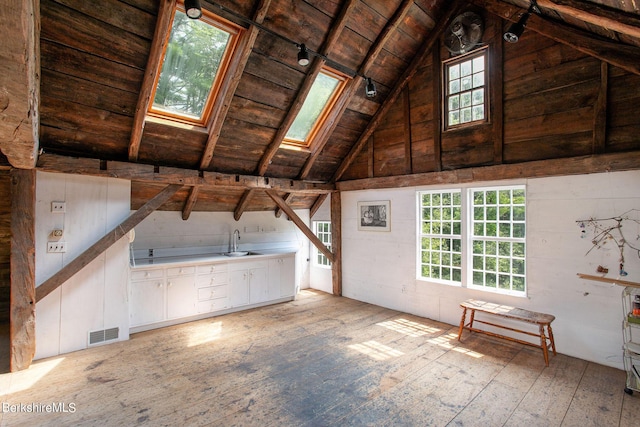 unfinished attic with sink and a skylight