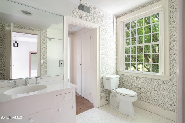 bathroom featuring tile patterned floors, vanity, and toilet