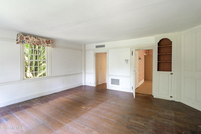 empty room with dark wood-type flooring