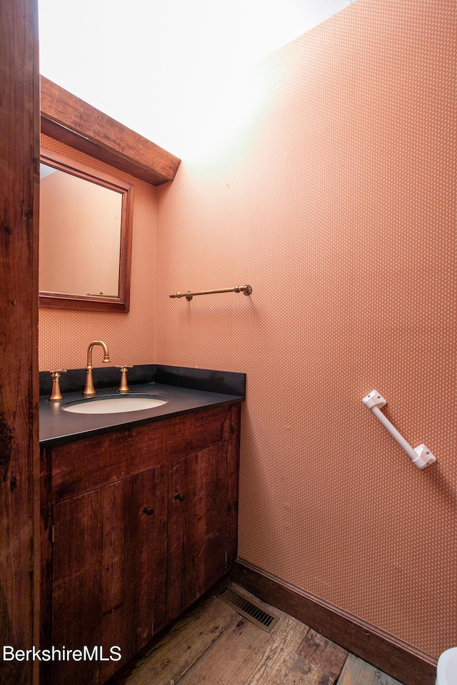 bathroom featuring hardwood / wood-style flooring and vanity