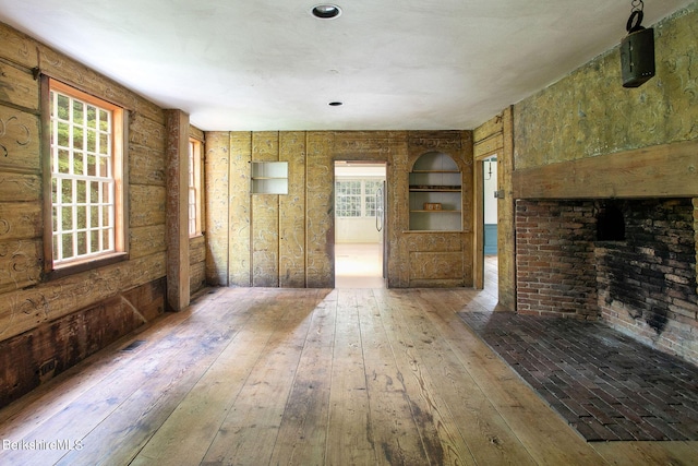 unfurnished living room with wood-type flooring