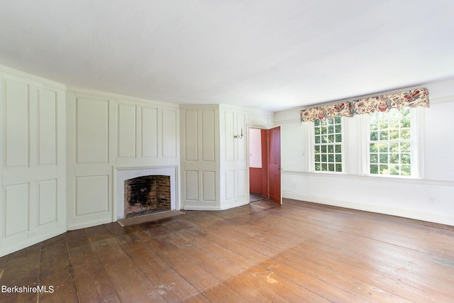 unfurnished living room with hardwood / wood-style flooring