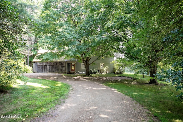 obstructed view of property with a front lawn