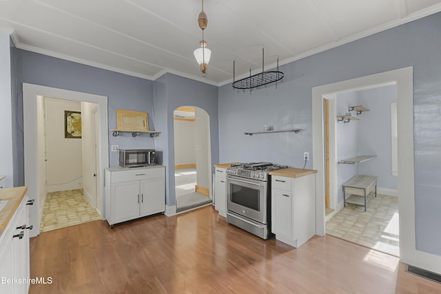 450 E Main St, North Adams, MA 01247 - kitchen with stainless steel appliances, arched walkways, wood counters, white cabinetry, and crown molding