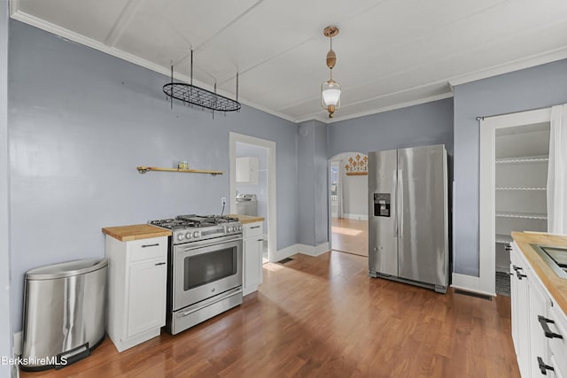 450 E Main St, North Adams, MA 01247 - kitchen with wooden counters, appliances with stainless steel finishes, washer / clothes dryer, white cabinetry, and arched walkways
