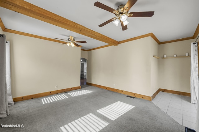 450 E Main St, North Adams, MA 01247 - carpeted spare room featuring a ceiling fan, crown molding, beamed ceiling, tile patterned floors, and arched walkways