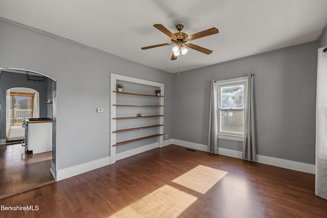 450 E Main St, North Adams, MA 01247 - unfurnished room featuring arched walkways, ceiling fan, wood finished floors, and crown molding