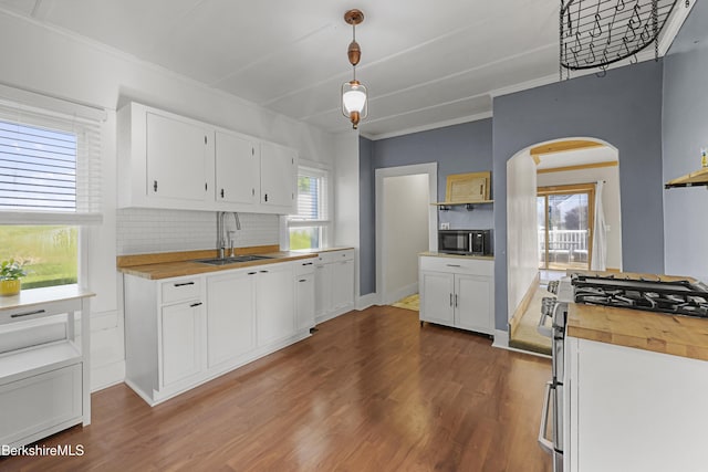 450 E Main St, North Adams, MA 01247 - kitchen featuring appliances with stainless steel finishes, arched walkways, butcher block counters, white cabinetry, and dark wood-style floors