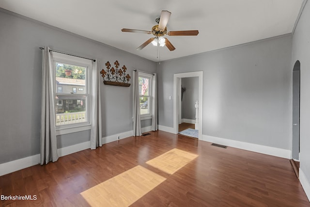 450 E Main St, North Adams, MA 01247 - empty room with arched walkways, a ceiling fan, wood finished floors, and ornamental molding