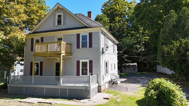 view of front of home with covered porch and a balcony