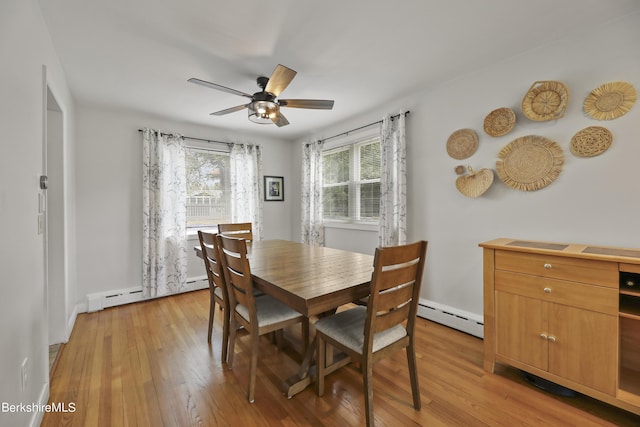 dining room featuring baseboard heating, light wood-style flooring, and ceiling fan