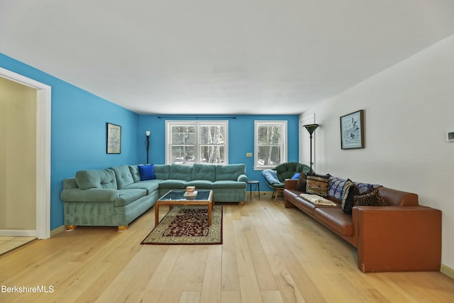 living room with light wood-style flooring and baseboards