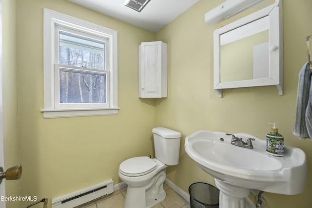 half bathroom with visible vents, baseboards, toilet, tile patterned floors, and a baseboard radiator