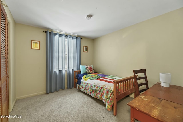 bedroom with baseboards, a closet, and carpet floors