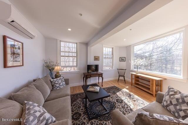 10 Deerfield Ave Unit 5, Shelburne, MA 01370 - living room featuring light hardwood / wood-style flooring and an AC wall unit