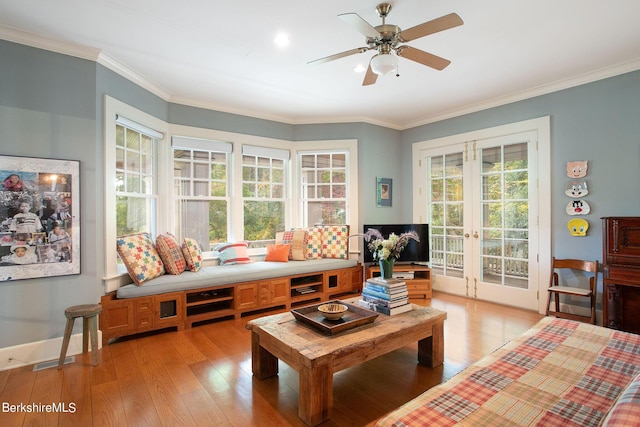 living room with crown molding, french doors, ceiling fan, and light hardwood / wood-style floors