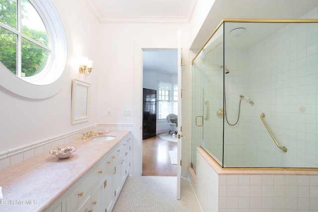 bathroom featuring vanity, tile patterned floors, a shower with door, and crown molding