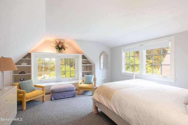 carpeted bedroom with lofted ceiling