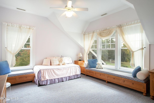 carpeted bedroom with ceiling fan and vaulted ceiling