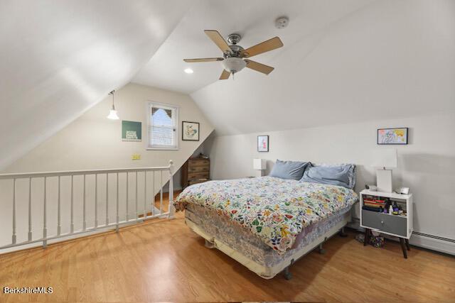 bedroom with lofted ceiling, wood finished floors, and ceiling fan