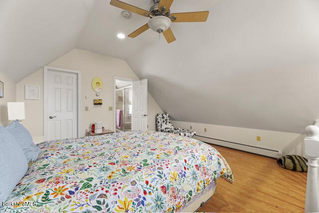 bedroom with wood finished floors, a ceiling fan, and vaulted ceiling