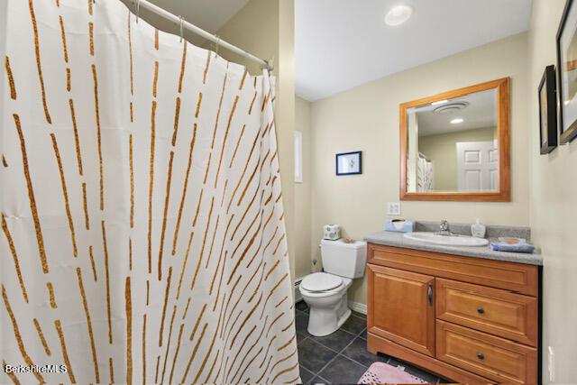 full bathroom featuring tile patterned floors, toilet, and vanity