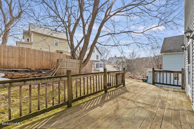 wooden terrace featuring fence